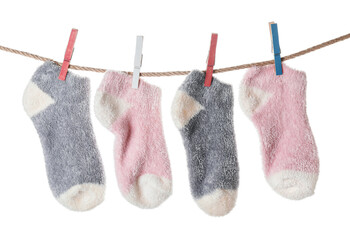 Warm socks hanging on clothes line against white background