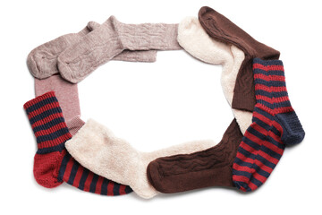 Frame made of warm socks on white background