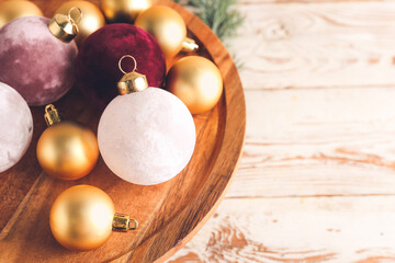 Beautiful Christmas balls on wooden stand, closeup