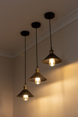 Three lamps with vintage incandescent bulbs with warm light