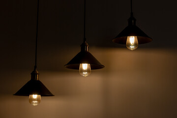 Three lamps with vintage incandescent bulbs with warm light