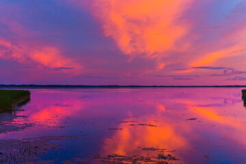 Obraz na płótnie Canvas Beautiful colorful sunset over the lake summer landscape.