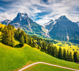 Spectacular morning view of Grindelwald village valley from cableway. Wetterhorn and Wellhorn...