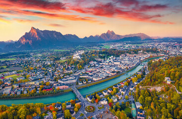 Aerial landscape photography. Exciting autumn view from flying drone of Salzburg, Old City. Spectacular sunrise on Eastern Alps. Fantastic morning landscape with Salzach river.