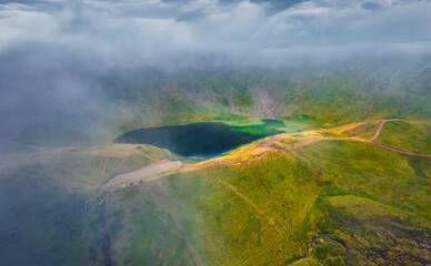 Aerial landscape photography. Foggy summer scene of popular tourist destination - Dohaska lake. Stunning morning view from flying drone of Carpathian mountains, Ukraine, Europe.