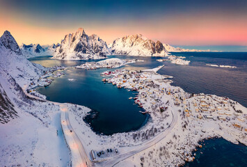 Unbelievable evening view from flying drone of popular tourist destination - Reine town. Wonderful sunset on Lofoten Islands, Norway, Europe. Gorgeous winter seascape of Norwegian sea.