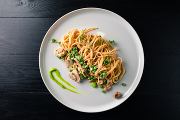 pasta with green peas, tuna and creamy sauce. spaghetti with green peas
