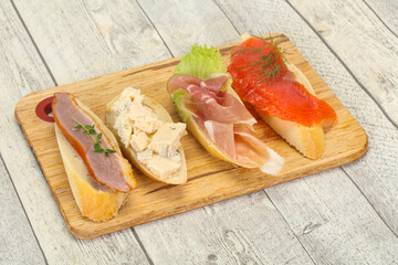 Tapas - bruschetta with prosciutto, salmon, duck and gorgonzola