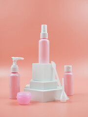 Pink cosmetic bottles for cream, gel, lotion. Skincare cosmetic concept.