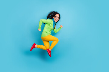 Full body profile side photo of happy young woman jump air run copyspace wear green shirt isolated on blue color background