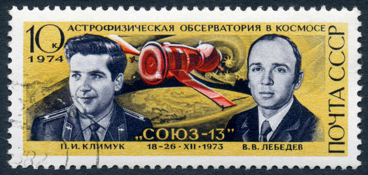 USSR - CIRCA 1974: A stamp printed in USSR, shows astrophysical observatory in space, union-13, and two cosmonauts, Klimuk and Lebedev. circa 1974