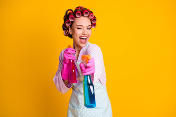 Photo of girl hold shoot spray bottle wink blink wear lilac bath robe apron gloves isolated shine color background