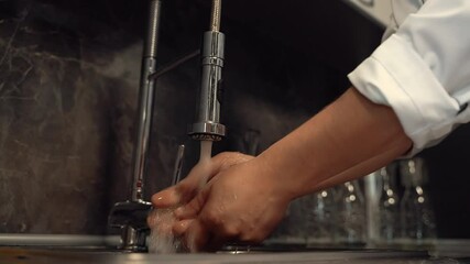 Proper hand washing in the kitchen sink, before cooking. Close-up.