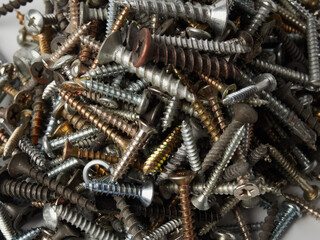 There are many metal self-tapping screws made of steel, self-tapping screw for metal, self-tapping screw for iron, chrome-plated self-tapping screw, scattered screws as background