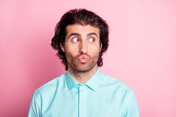 Photo of young handsome man lips pouted plump look empty space isolated over pink color background