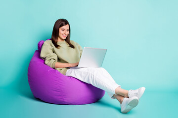 Photo portrait full body view of woman typing on laptop sitting in purple armchair isolated on...