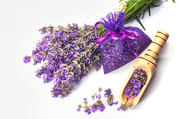 Fragrant bag or pouch with lavender flowers on white background. Sprigs of lavender near the sachet...