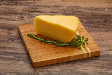 Hard cheese piece served rosemary