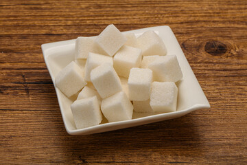 Refined white sugar cubs in the bowl