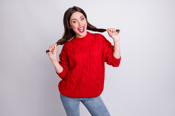 Photo portrait of careless childish girl keeping hair tails funny red knitted sweater smiling...
