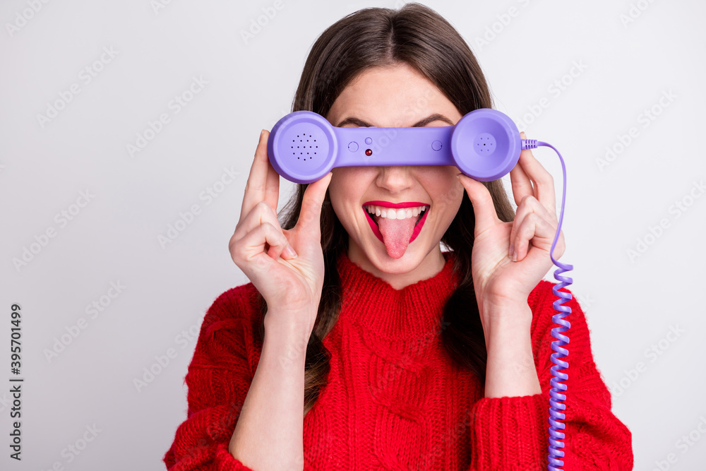 Poster Photo portrait of childish careless girl fooling hiding eyes behind purple phone handset isolated on pastel grey color background