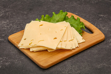 Sliced yellow cheese over board