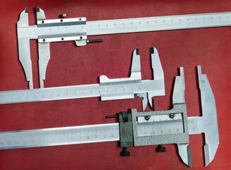 Three Measuring tool on a red background