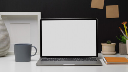 Fototapeta premium Workspace with laptop, stationery and decorations in home office room