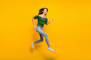 Obraz na płótnie Canvas Full size profile side photo of funky woman run jump up copyspace discount shopping isolated on yellow color background