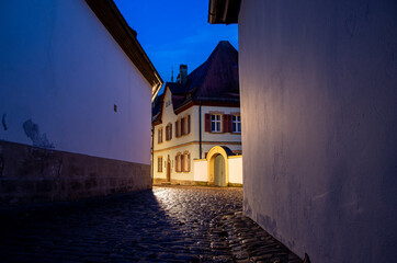 Narrow historical alley in the old town of Bamberg at night, World Heritage Site City of Bamberg, Germany. High quality photo