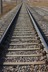 Fototapeta na wymiar Inside the vintage railroad tracks, Steel railway for trains, Railroad without train, Sunny day on Railway line