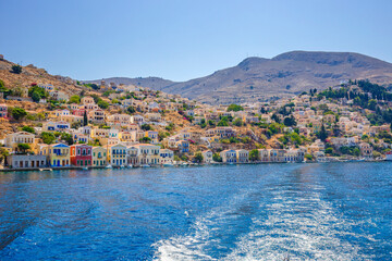 View of beautiful bay with colorful houses on the hillside of the island of Symi. Greece