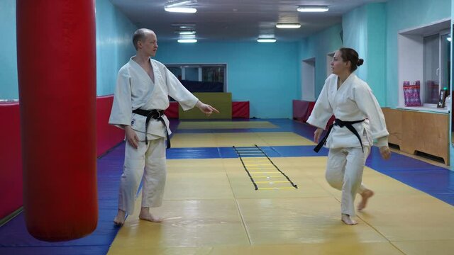 Novosibirsk, Russia-11.26.2020: Martial arts, hand-to-hand combat. A man and a woman with black belts practice Aikido technique.
