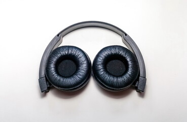 Black wireless headphones for audio electronic devices close up on white background