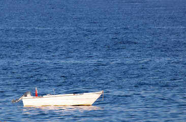 small white boat at sea