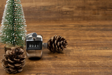 A handheld counter showing 2021 number with a model Christmas tree