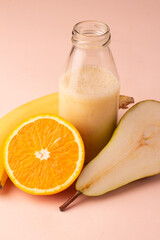 smoothies in a jar pear, orange and banana close-up.