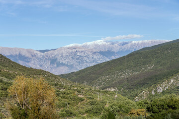 Fototapeta na wymiar summer snow and clouds on Maiella range, from near Casale, Abruzzo, Italy