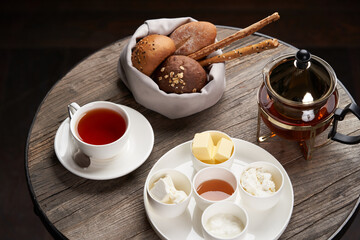 Hotel breakfast set on table with honey, tea, bread