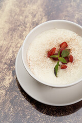 Oatmeal porridge with strawberry, raspberry and mint
