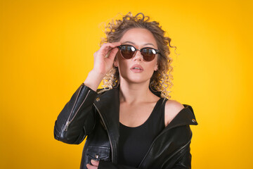 stylish hipster girl on yellow background