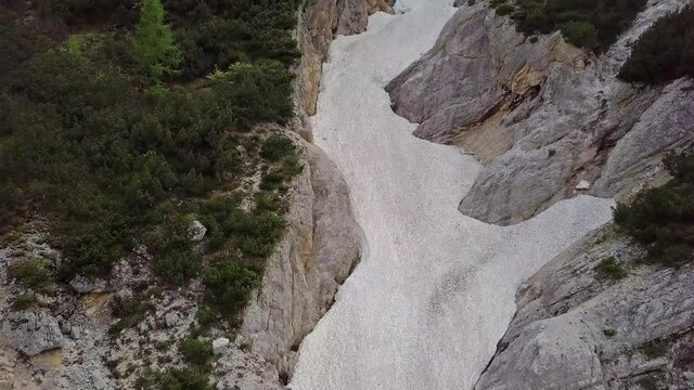 Aerial view of the mudflow with snow high in the Alpine mountains