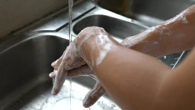Man washing hands, rubbing and cleaning thoroughly with soap. Protection from coronavirus concept.