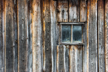Small window on wooden wall. wooden house wall.