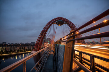 red cable-stayed bridge and freeway at sunrise on winter morning