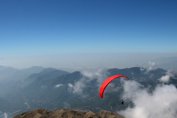 paragliding in the sky against the background of mountains