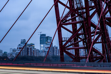 Fototapeta na wymiar red cable-stayed bridge and freeway at sunrise on winter morning