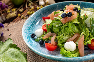 Fresh Caesar  salad in plate on wood table