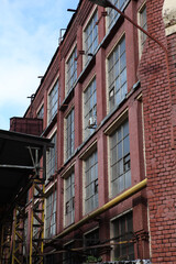 Moscow Electric Lamp Plant. Construction of industrial, industrial building. Ancient house facade....