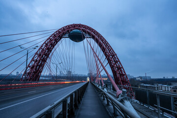 red cable-stayed bridge and freeway at sunrise on winter morning